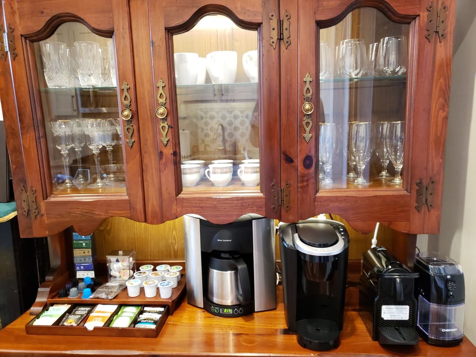 Drip coffee maker, Nespresso, Keurig, and bur grinder. Provided coffee and tea.