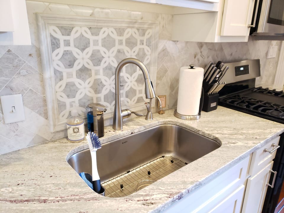 Marble backsplashes and granite counter tops throughout apartment.