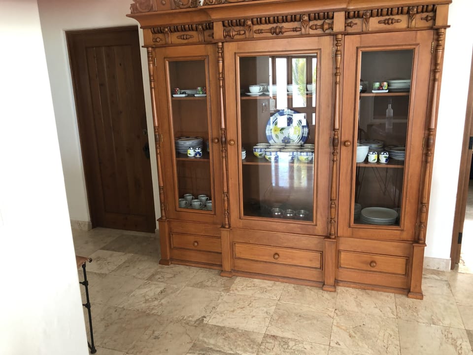 Mexican china cabinet with dishes, 2/3rd bedrooms to the left