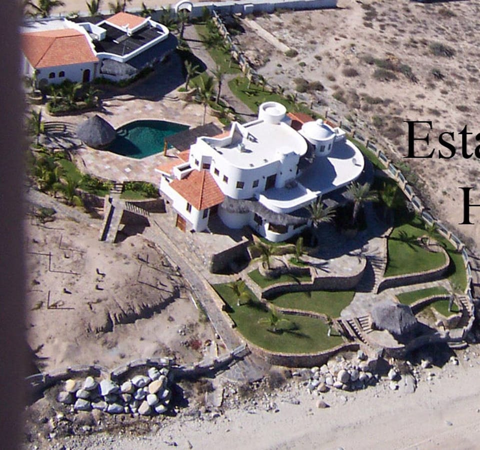 areal photo, original color white. Beach, main house, pool, guesthouse top left