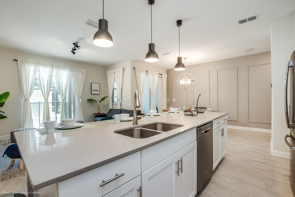 Well-Designed Kitchen of the townhouse in Kissimmee Florida - Integrated appliances for a seamless and stylish appearance - Thoughtful placement of kitchen essentials for easy access - Coordinated kitchen decor for inviting atmosphere