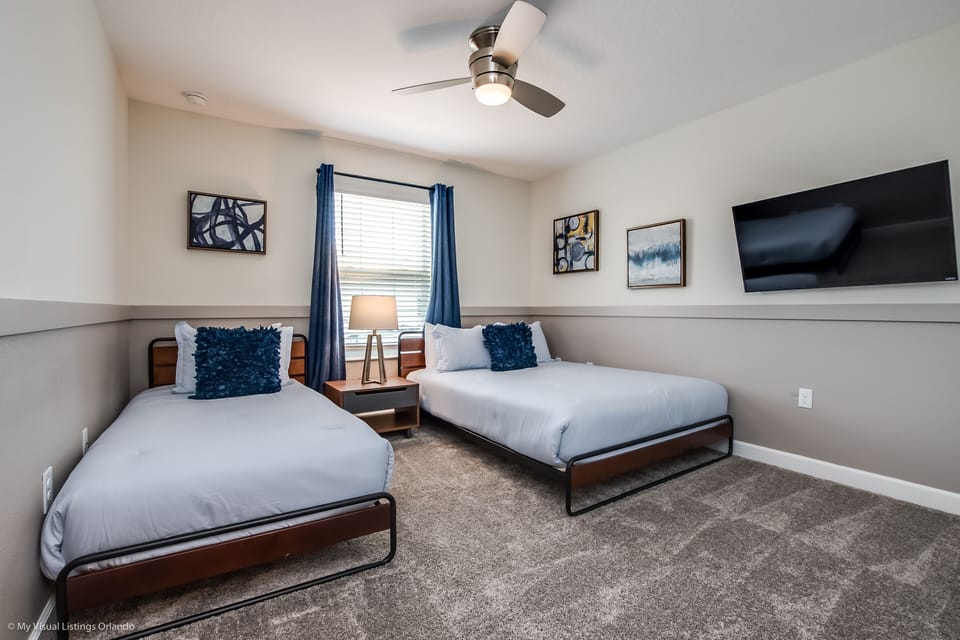 Spacious bedroom of the townhouse in Kissimmee Florida - Features two comfortable beds and smart TV, perfect for relaxing - Plenty of sleeping space and cozy bedding, this room offers a restful retreat for a peaceful night's sleep