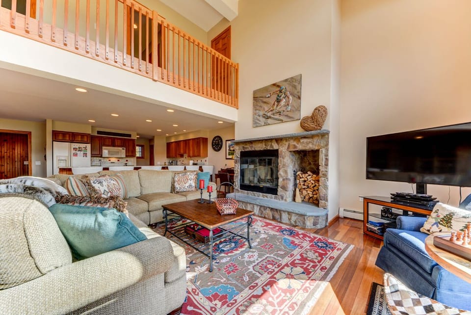 The comfortable furniture that surrounds the beautiful wood burning stone fireplace.