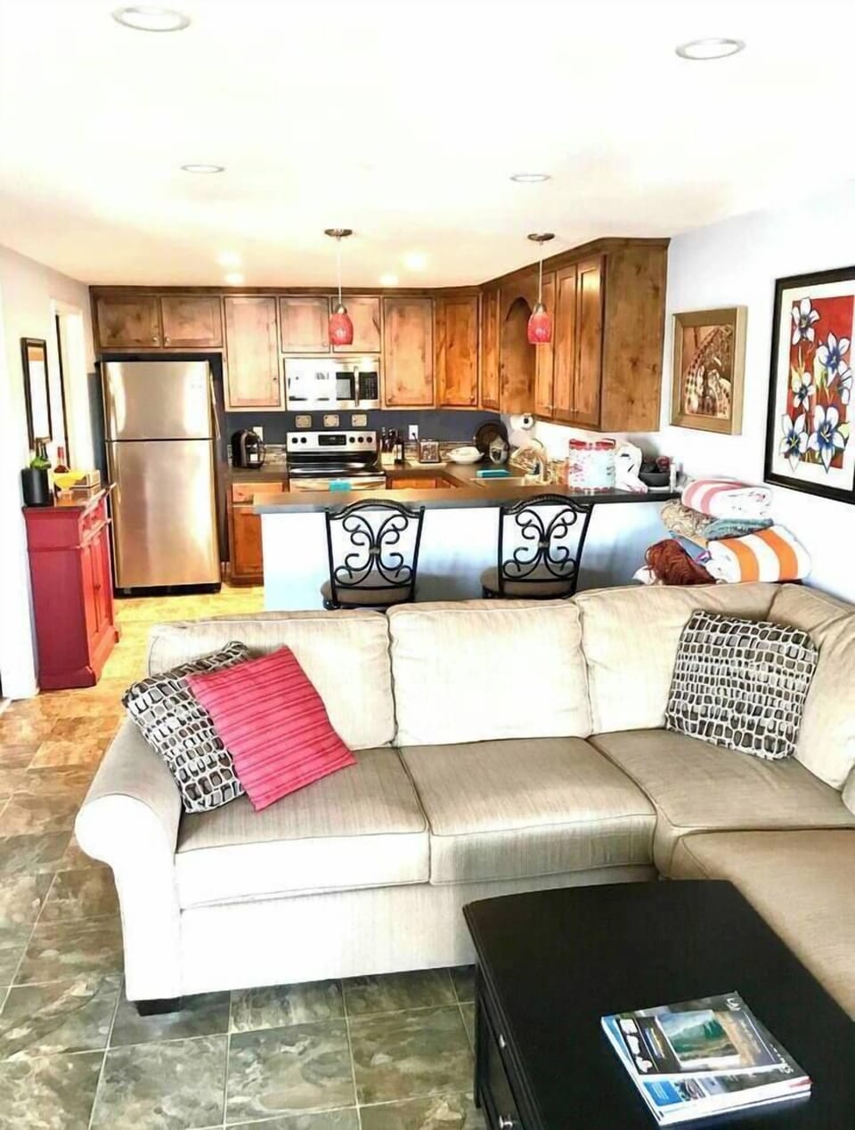 Open concept kitchen and living room with swivel bar height chairs for dining at the kitchen bar and swivel to look at the lake views. 