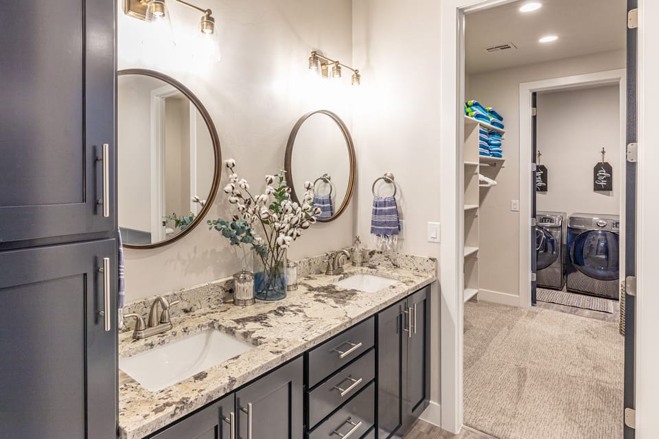 Main Bathroom - With access to the walk-in closet and laundry room this large and spacious bathroom also includes a walk-in shower, bath tub, his and her sinks, toilet and large vanity.