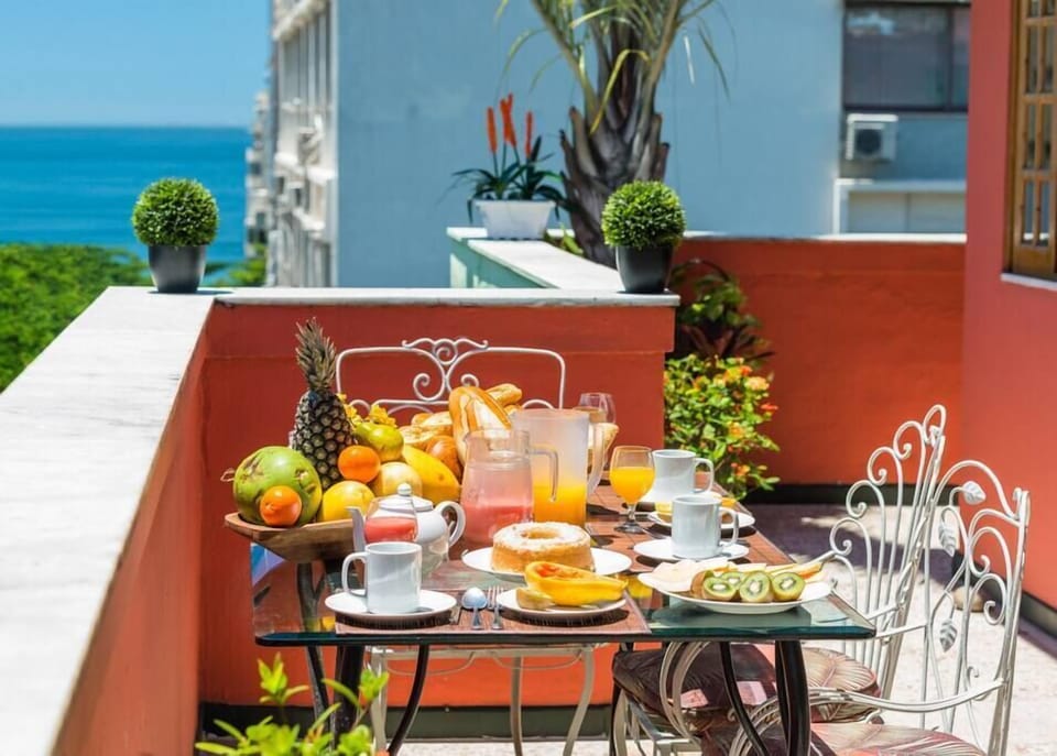Breakfast table on the terrace with views of the beach and mountains. 