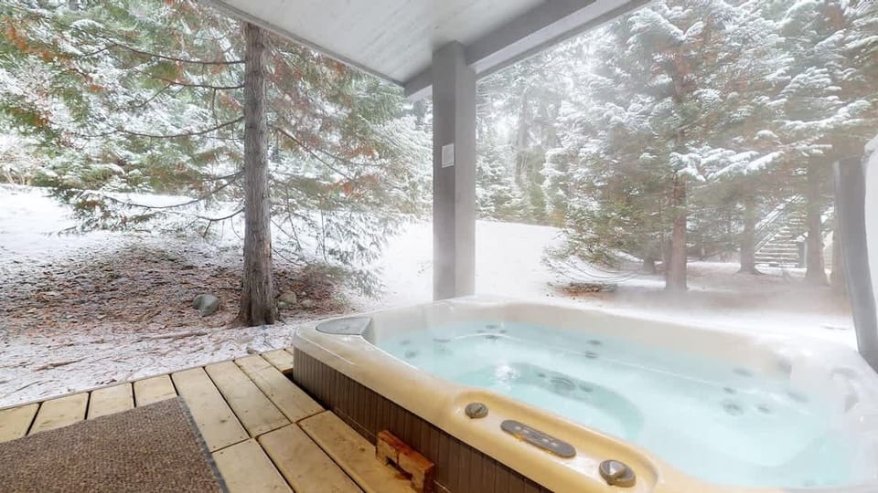 - Private hot tub steaming amid snow-covered pines for ultimate relaxation  
- Soak in warmth while snow gently falls around the serene forest view  
- Perfect spot to unwind after skiing or a day exploring mountain trails  