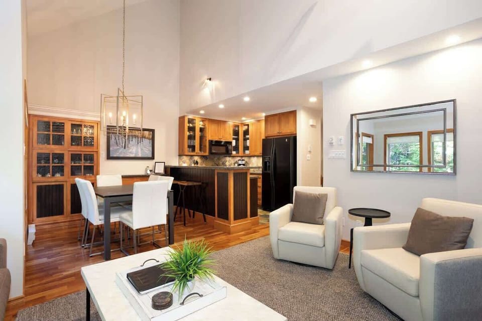 - Bright open living space with soft furnishings and cozy mountain ambiance  
- Ideal for relaxing with family, sharing stories, or warming up by the fire  
- Large windows connect indoor comfort to the surrounding forest scenery 