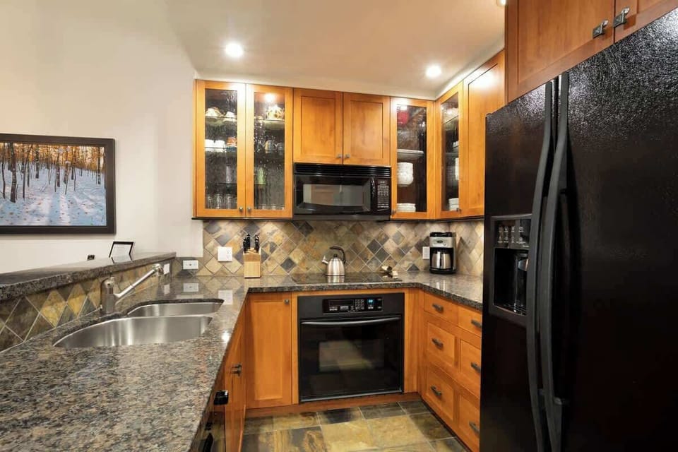 - Fully equipped kitchen with granite counters and wood cabinetry for comfort  
- Modern appliances make it easy to cook hearty meals after a day outdoors  
- Perfect setup for family dinners or cozy gatherings with friends in the lodge  