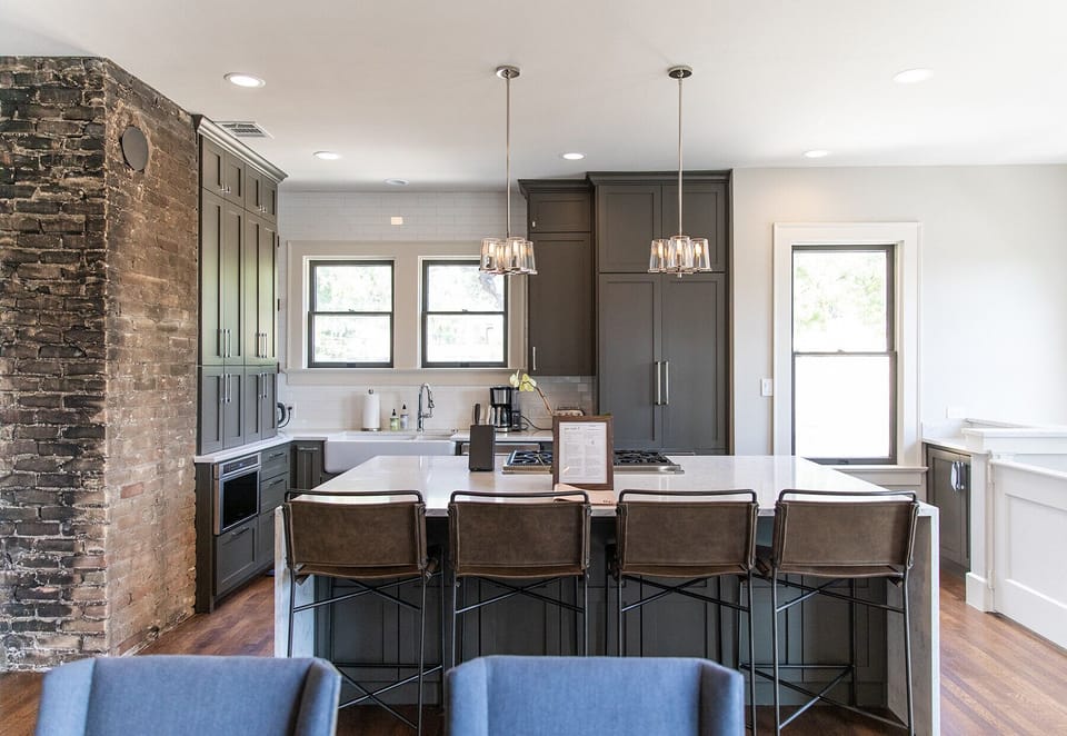 Kitchen with original brick accent and island seating