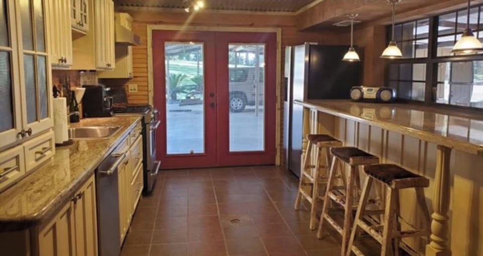 A second full kitchen in the basement with pass through windows to outside 