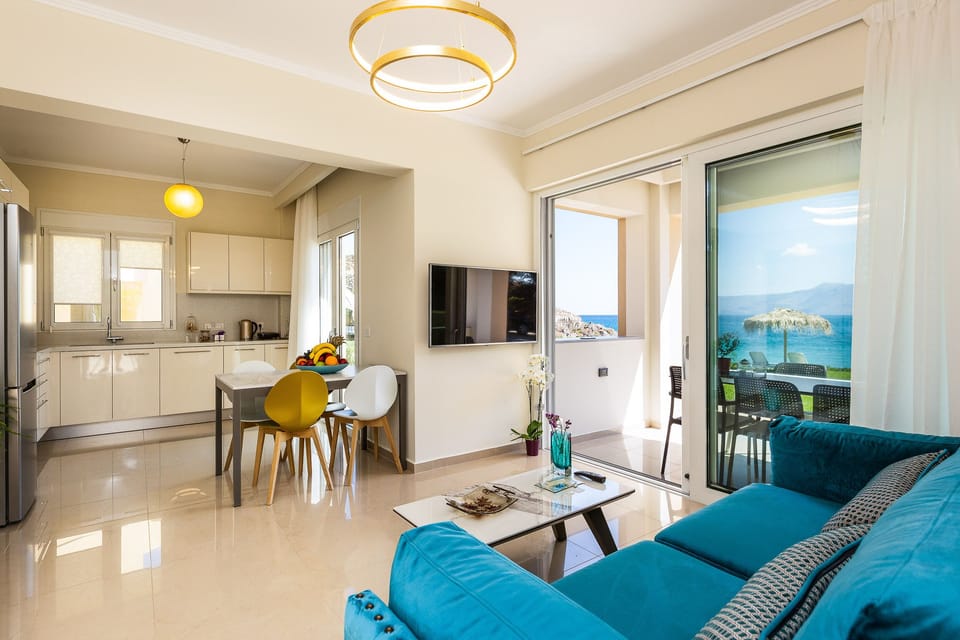 Open plan area featuring the kitchen, dining table and living room.