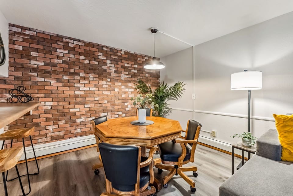Dining Area: 4-person dining table, charming exposed brick wall, connected to kitchen and living room
