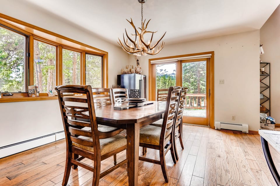 The dining room has a large table that seats 6 with additional seating for 4 at the kitchen counter. There are lots of windows with views and a sliding door to access the patio and grill.