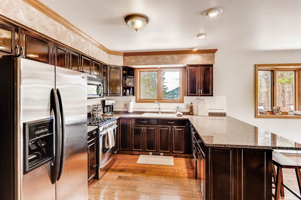 The large kitchen beautiful granite counter tops and stainless appliances. It is open to the great room and dining room.
