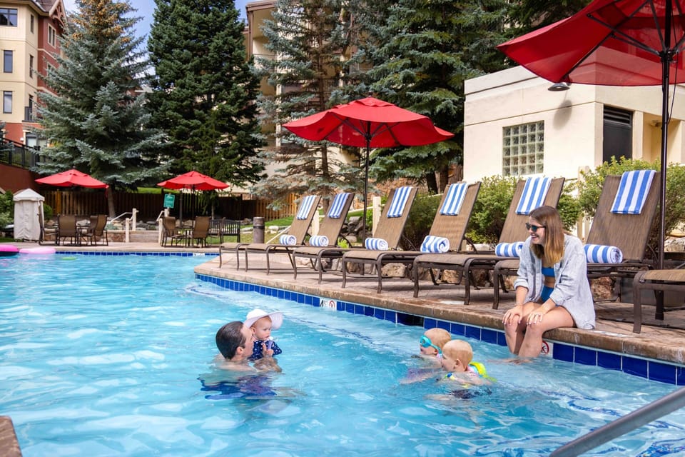Splash and play in the outdoor pool, where sunny loungers and vibrant umbrellas create a welcoming retreat. The scenic mountain surroundings make every dip refreshing.