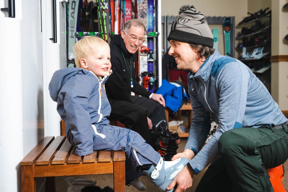 The ski shop team helps your little one gear up for adventure—friendly, patient, and ready to make sure everything fits just right.