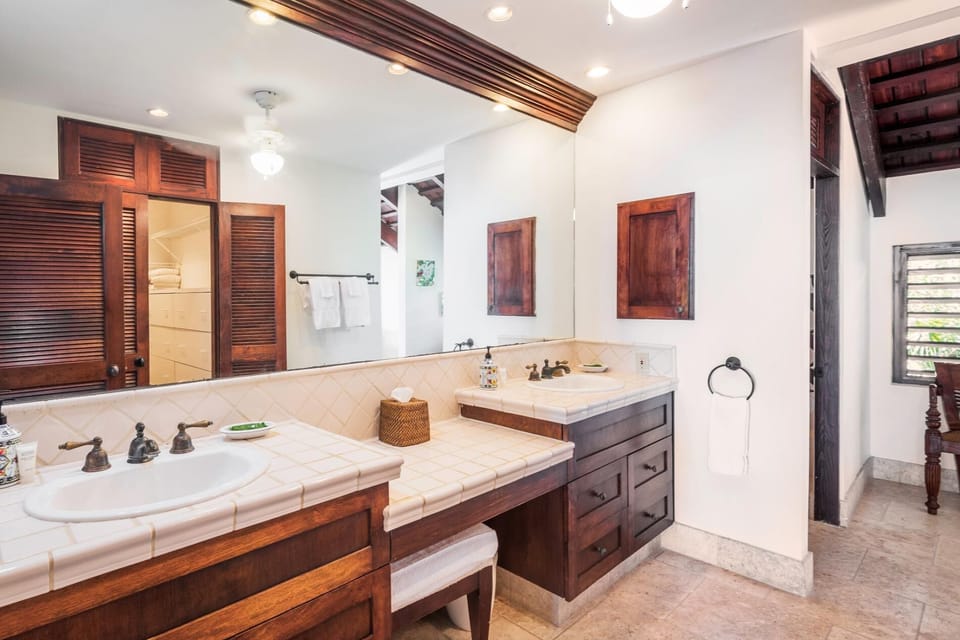The master bathroom has double vanities and a large walk in closet