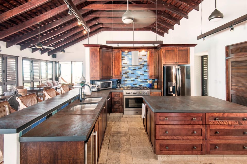 The large kitchen in the main house provides ample space to prepare meals. The kitchen features a large gas stove and oven, electric oven, a large refrigerator and separate ice maker. The kitchen is fully stocked with all necessary pots, pans and utensils