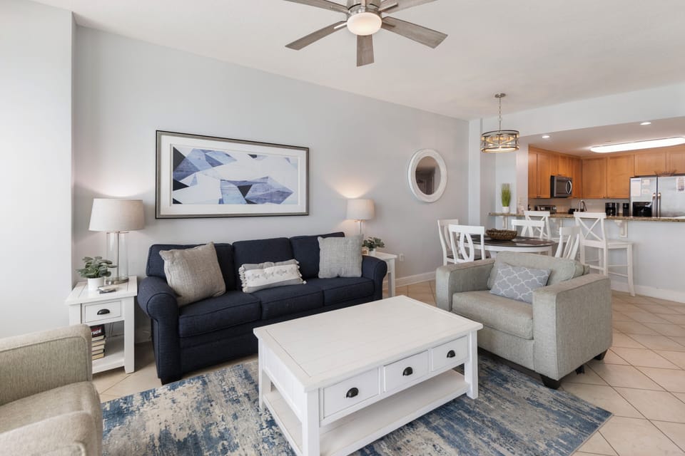 Relax in your bright, coastal-inspired living space with plush seating and an open layout connecting to your fully equipped kitchen.