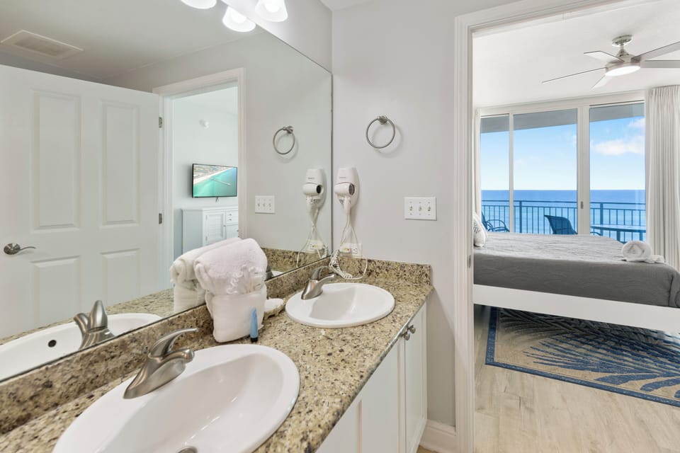 Your private bathroom features granite counters, premium amenities, and opens to a stunning oceanfront bedroom.