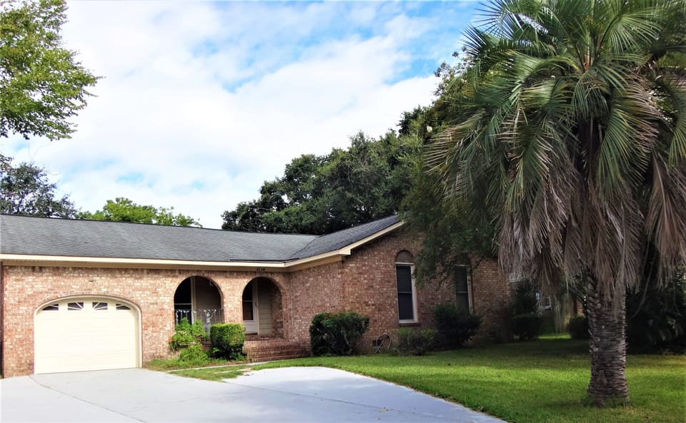 Spanish architecture brick house. Expanded driveway for parking
