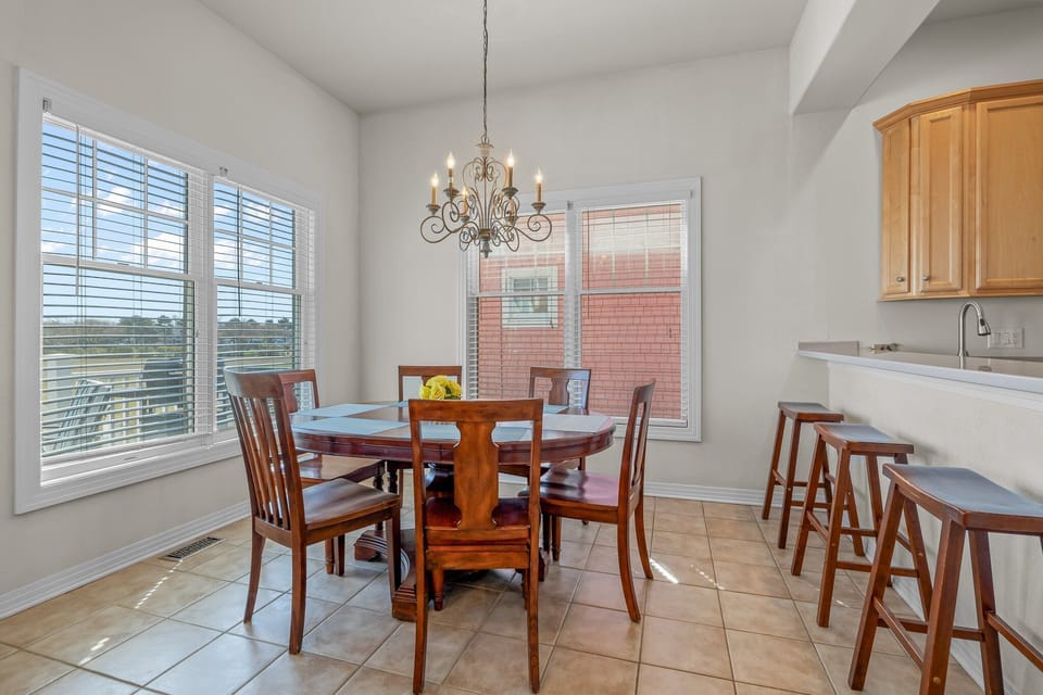 Dining room with seating for six and three seats at the bar area