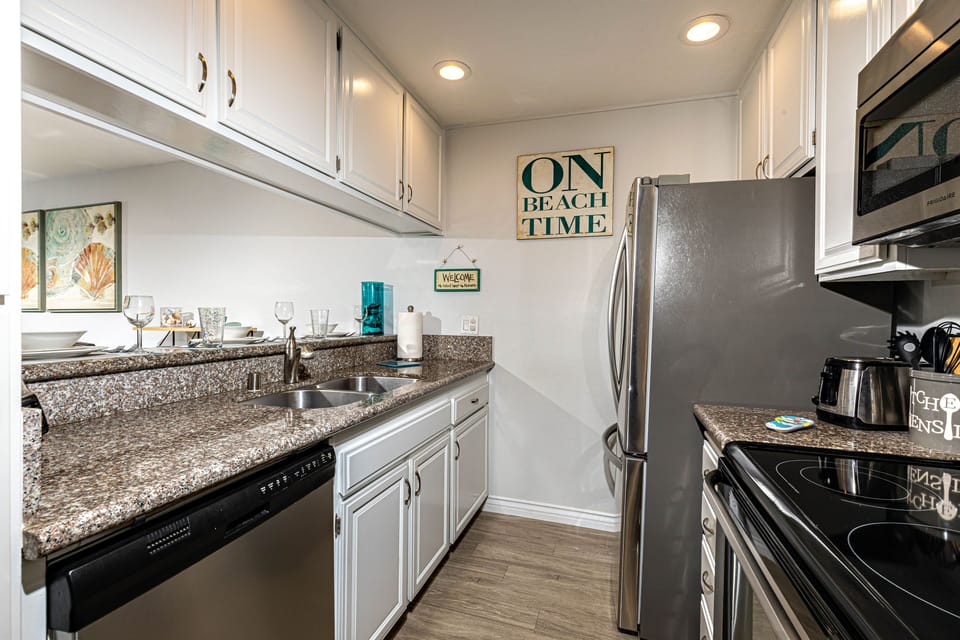 The kitchen is equipped with dishes, pots and pans,  and cooking utensils.