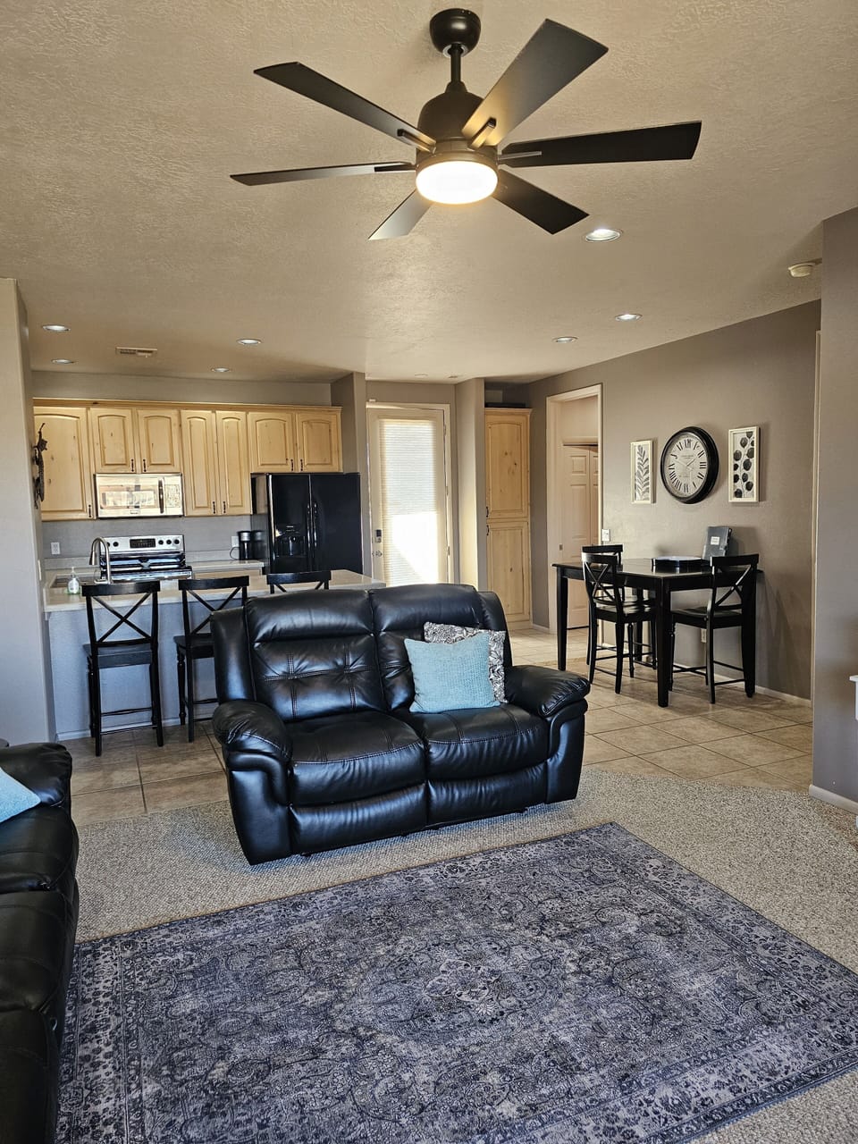 Living room looking into kitchen and front door