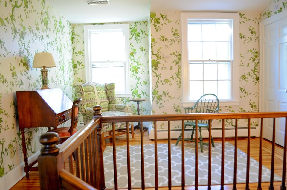 The landing offers another quiet place to read or write.