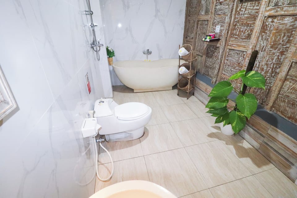 Deluxe Room, Pool View | Bathroom | Shower, deep soaking tub, rainfall showerhead, hair dryer