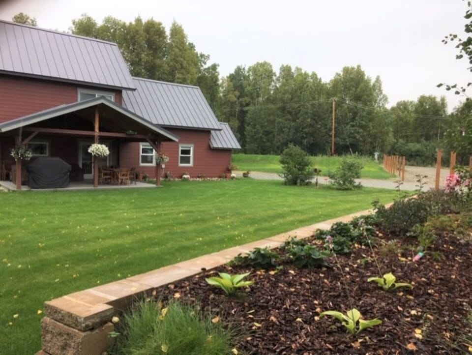 Front yard view by flower bed.