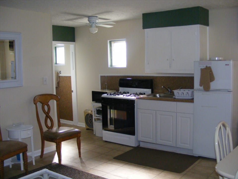 Kitchen; stove, refrigerator, microwave, toaster oven & cooking utensils.