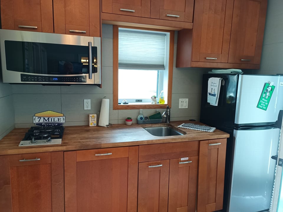Butcher block counters with DISHWASHER, gas cook-top, combo microwave / convection oven / air fryer.