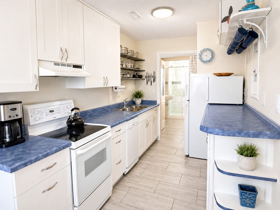 Fully stocked kitchen with all essentials plus a dishwasher. Bathroom through the doorway at the end.