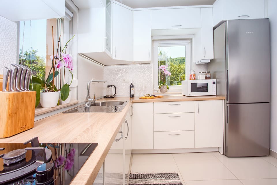 Well lit, fully-equipped, modern kitchen with nice outside view