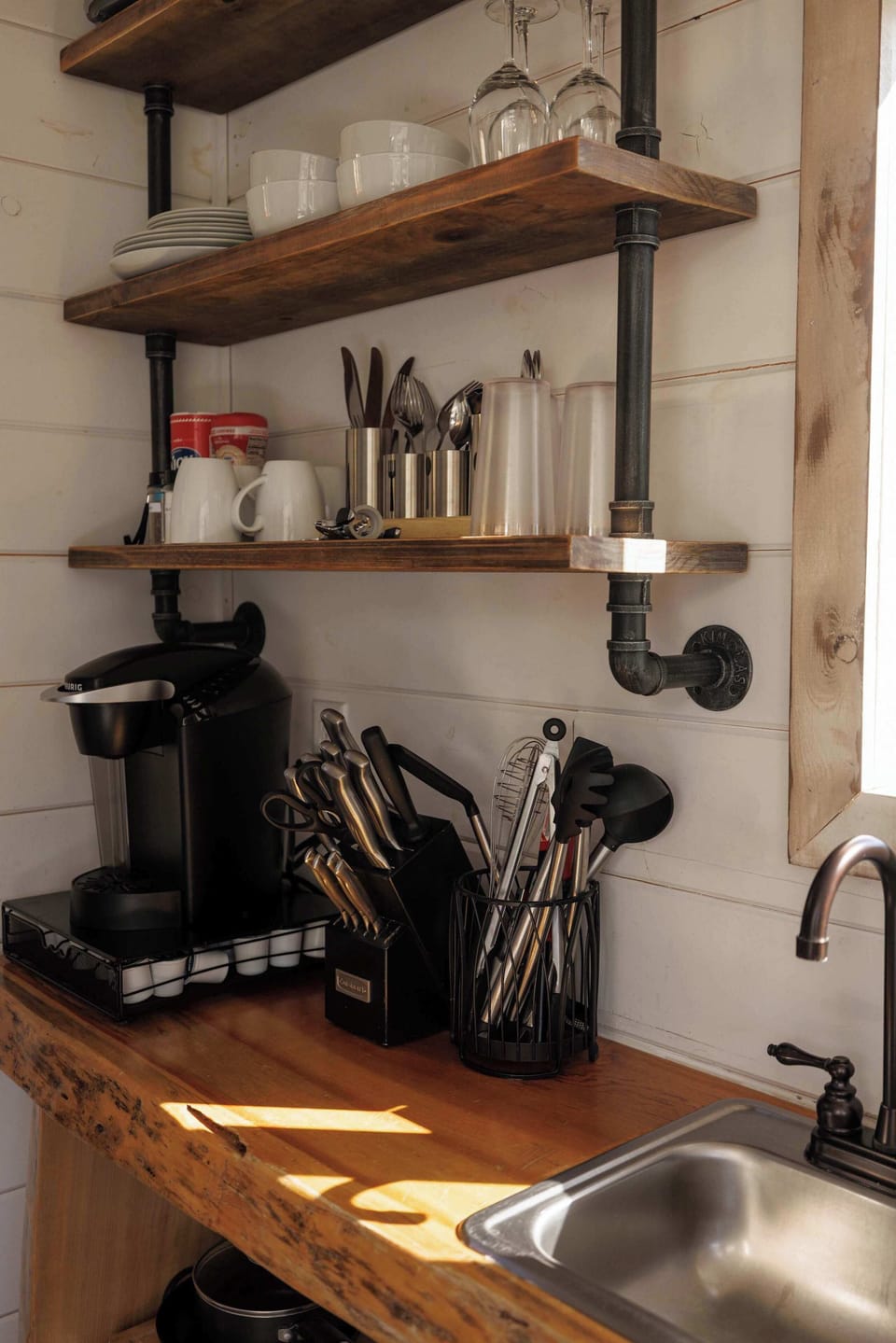 Well-stocked kitchenette inside your Treetop cabin with a Keurig, dishes, glassware, utensils, cookware, and essentials for simple meals during your Southern Utah stay.