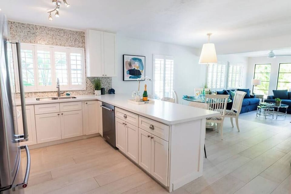 Open floor plan allows to move freely from the kitchen to dining area to living room with just a step down. 