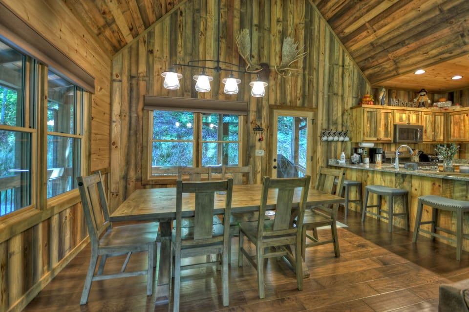 Dining area with table that seats 6 plus 3 bar stools at the kitchen counter