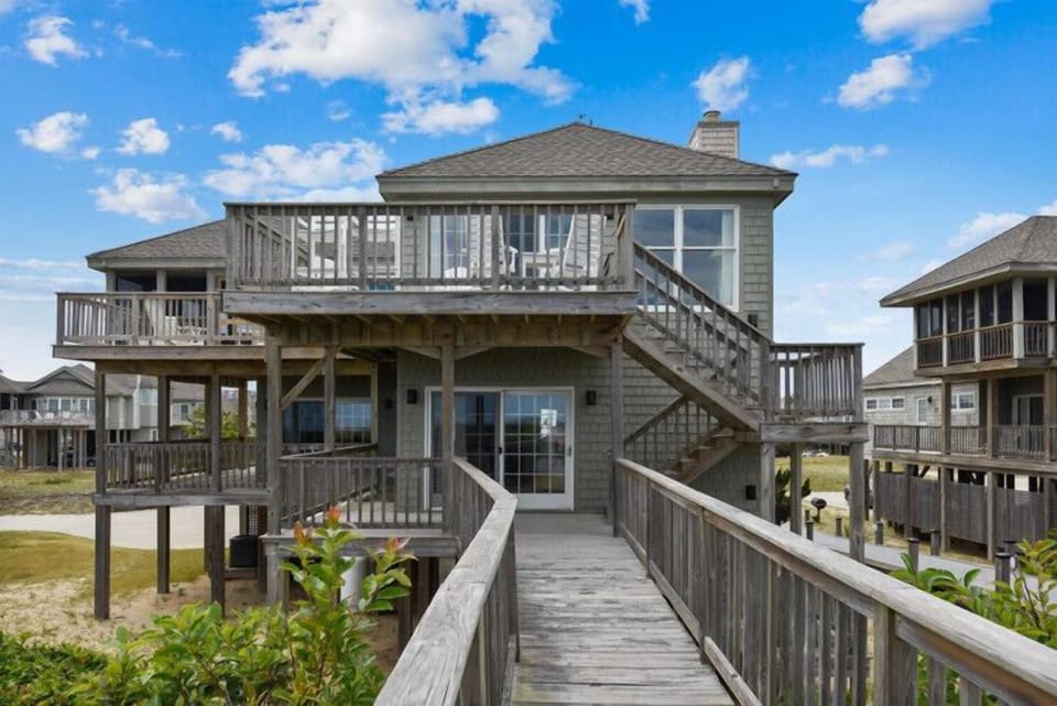 Elevated beachside home with spacious wraparound decks and direct boardwalk access—your coastal escape is just steps from the sand.