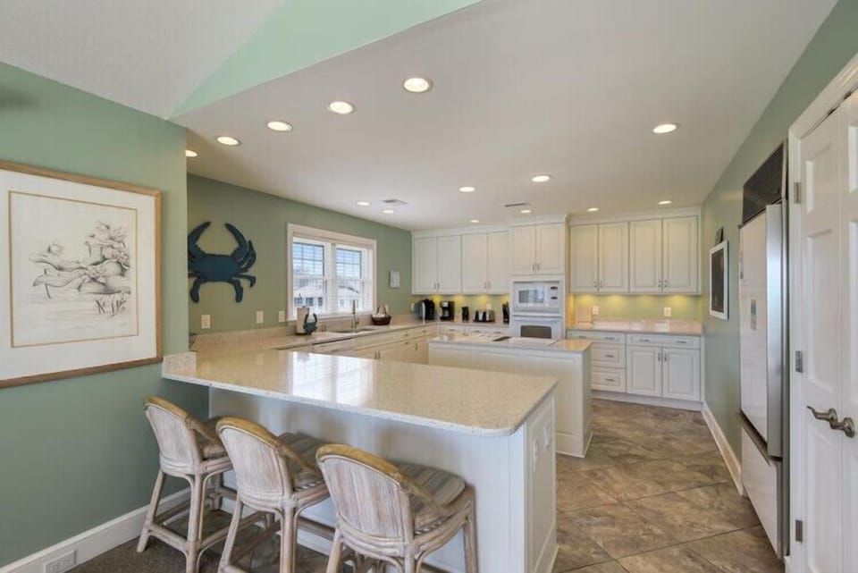 Your spacious kitchen features granite countertops, stainless appliances, and a breakfast bar perfect for morning coffee or casual meals together.
