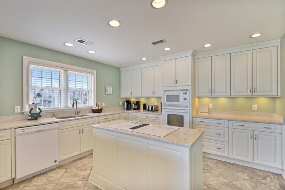 Your spacious kitchen features granite countertops, a large center island, and modern appliances—ready for you to prepare meals and entertain with ease.