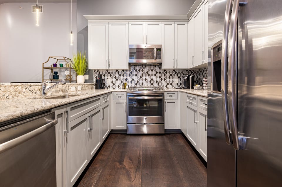 Cook and dine easily in the fully stocked kitchen, equipped with all stainless steel appliances, gas range, basic cookware, and a dining area for a comfortable meal at home. Entertain at the bar with seating for four.