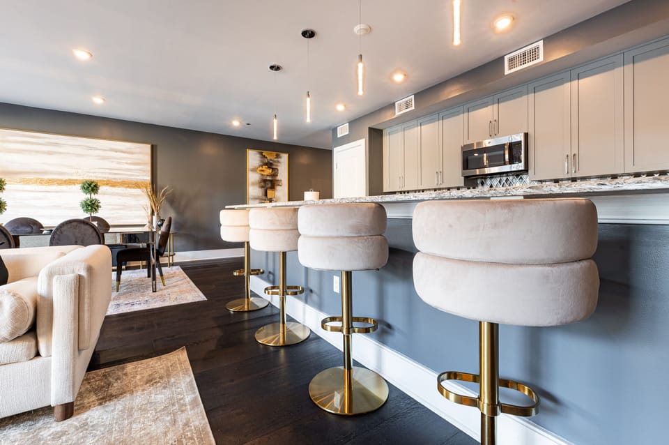 Cook and dine easily in the fully stocked kitchen, equipped with all stainless steel appliances, gas range, basic cookware, and a dining area for a comfortable meal at home. Entertain at the island with seating for four.