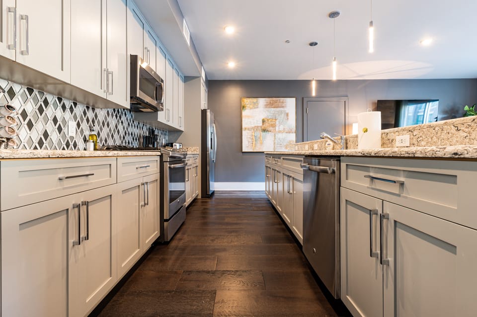 Cook and dine easily in the fully stocked kitchen, equipped with all stainless steel appliances, gas range, basic cookware, and a dining area for a comfortable meal at home. Entertain at the island with seating for four.