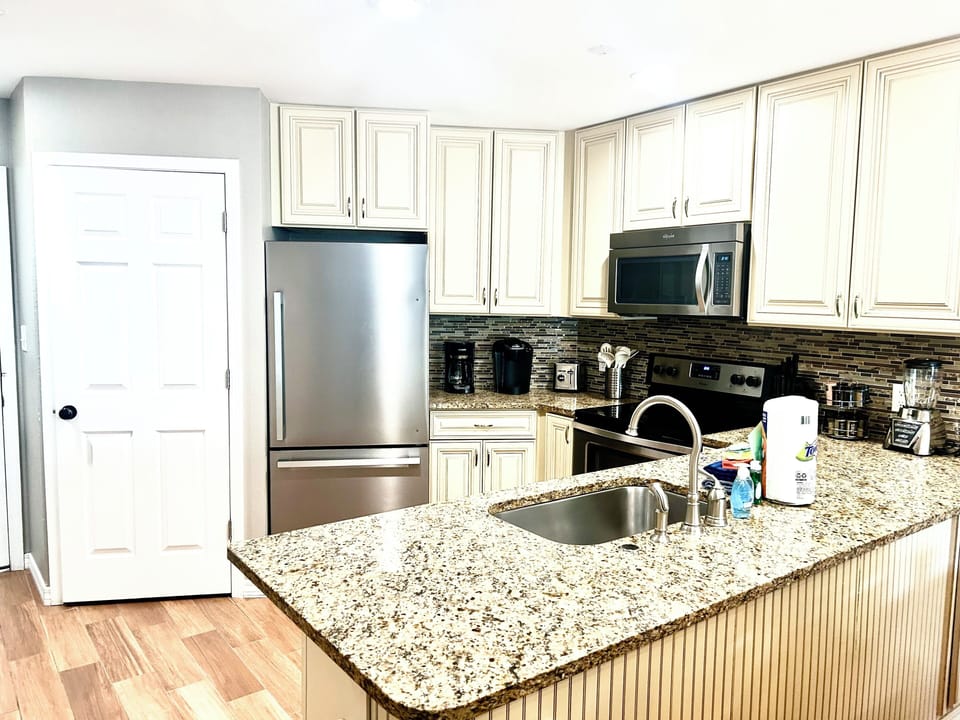Fully equipped up-graded kitchen with granite and stainless appliances.