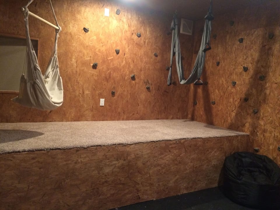 Yoga studio with rock holds.Stage is carpeted-perfect for lounging or stretching