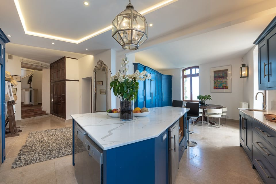 Chef kitchen with one of 4 dining areas and direct access to terraces.