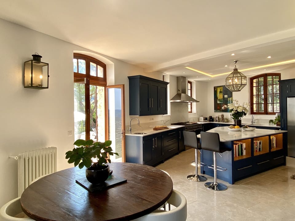 Chef kitchen with one of 4 dining areas and direct access to terraces.