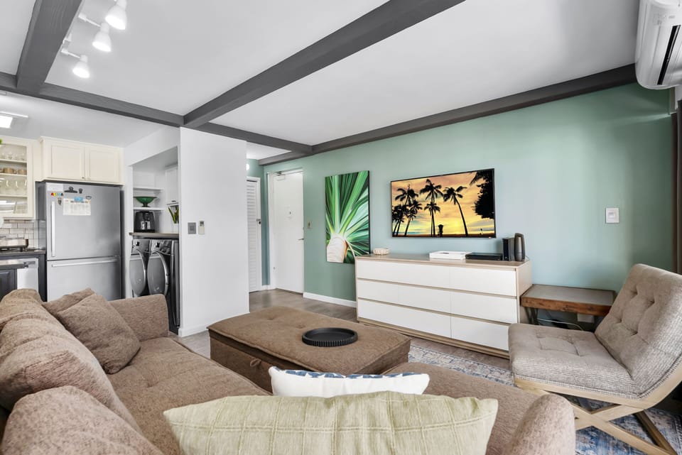 Entry opens to the living room beside a full kitchen with in-unit laundry.